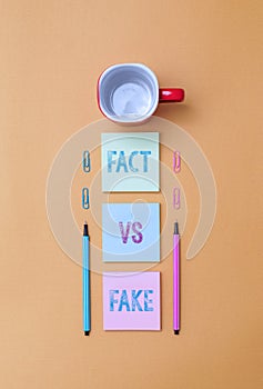 Text sign showing Fact Vs Fake. Conceptual photo Rivalry or products or information originaly made or imitation Coffee photo