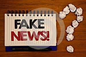 Text sign showing Fake News Motivational Call. Conceptual photos False Unsubstantiated Information HoaxIdeas on notebook wooden ba