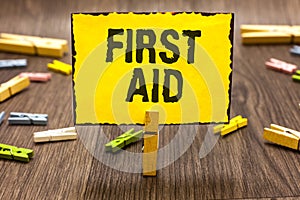 Text sign showing First Aid. Conceptual photo Practise of healing small cuts that no need for medical training Clothespin holding