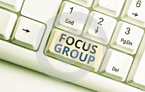 Text sign showing Focus Group. Conceptual photo showing assembled to participate in discussion about something White pc