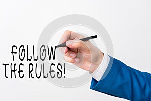 Text sign showing Follow The Rules. Conceptual photo go with regulations governing conduct or procedure Isolated hand photo