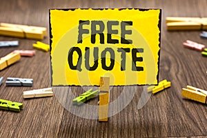 Text sign showing Free Quote. Conceptual photo A brief phrase that is usualy has impotant message to convey Clothespin holding yel