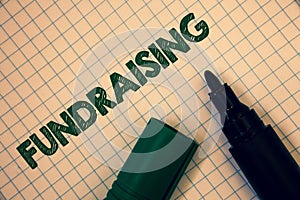 Text sign showing Fundraising. Conceptual photo Seeking of financial support for charity cause or enterprise Squared paper open ma