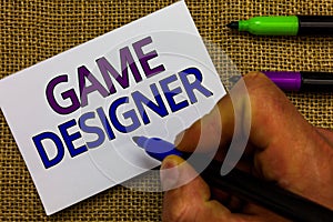 Text sign showing Game Designer. Conceptual photo Campaigner Pixel Scripting Programmers Consoles 3D Graphics Man hand holding mar