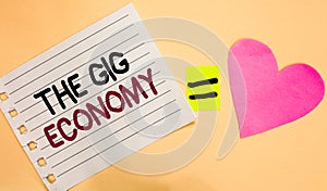 Text sign showing The Gig Economy. Conceptual photo Market of Short-term contracts freelance work temporary Transverse white paper