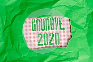 Text sign showing Goodbye 2020. Conceptual photo New Year Eve Milestone Last Month Celebration Transition Green crumpled photo