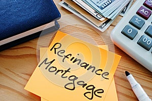 Text sign showing hand written words refinance mortgage photo