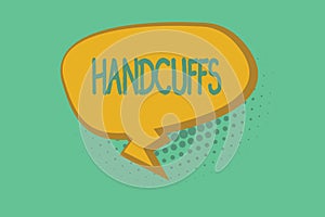 Text sign showing Handcuffs. Conceptual photo Pair of lockable linked metal rings for securing a prisoner