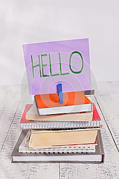 Text sign showing Hello. Conceptual photo used as a greeting or to begin a telephone conversation Greet someone pile stacked books
