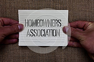 Text sign showing Homeowners Association. Conceptual photo Organization with fee for upkeeps of Gated Community Man holding piece