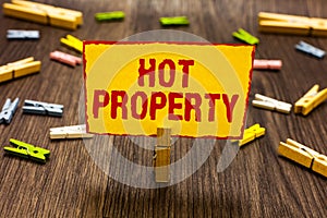 Text sign showing Hot Property. Conceptual photo Something which is sought after or is Heavily Demanded Clothespin holding yellow