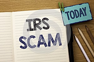 Text sign showing Irs Scam. Conceptual photo Warning Scam Fraud Tax Pishing Spam Money Revenue Alert Scheme written on Notebook Bo