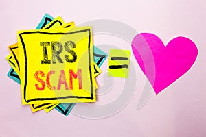 Text sign showing Irs Scam. Conceptual photo Warning Scam Fraud Tax Pishing Spam Money Revenue Alert Scheme written on Stacked Sti