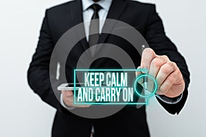 Text sign showing Keep Calm And Carry On. Conceptual photo slogan calling for persistence face of challenge Presenting