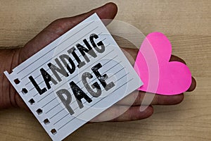 Text sign showing Landing Page. Conceptual photo Website accessed by clicking a link on another web page Man holding piece noteboo