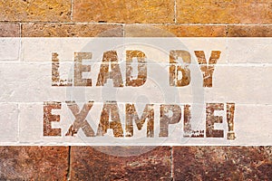 Text sign showing Lead By Example. Conceptual photo Be a mentor leader follow the rules give examples Coach Brick Wall