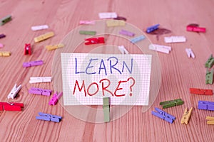 Text sign showing Learn More question. Conceptual photo gain knowledge or skill studying practicing Colored clothespin
