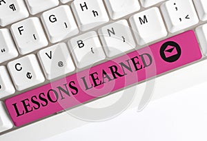 Text sign showing Lessons Learned. Conceptual photo the knowledge or understanding gained by experience White pc