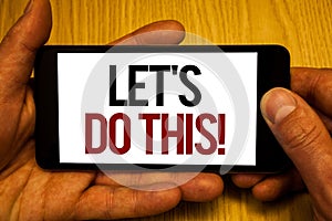 Text sign showing Let Us Do This Motivational Call. Conceptual photo Encourage to start something Inspirational Two hands holding