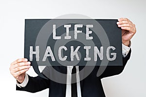 Text sign showing Life Hacking. Business concept Simple and clever techniques in accomplishing task easily Businessman Holding