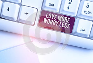 Text sign showing Love More Worry Less. Conceptual photo Have a good attitude motivation be lovable enjoy life White pc