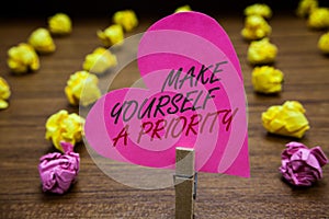 Text sign showing Make Yourself A Priority. Conceptual photo Think in your own good first personal development Paperclip hold pink