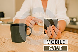 Text sign showing Mobile Game. Conceptual photo they are entertaining programs made to work on smart device woman using
