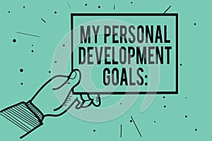 Text sign showing My Personal Development Goals. Conceptual photo Desires Wishes Career Business planning Man hand holding paper c