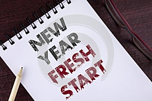 Text sign showing New Year Fresh Start. Conceptual photo Time to follow resolutions reach out dream job written on Notepad on the