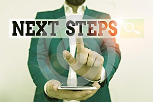 Text sign showing Next Steps. Conceptual photo something you do after you have finished doing first one Businessman in the blue