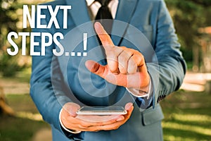 Text sign showing Next Steps. Conceptual photo something you do after you have finished doing first one Man with opened