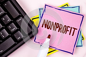 Text sign showing Nonprofit. Conceptual photo Activities that do not generate revenues to the executor written on Pink Sticky Note