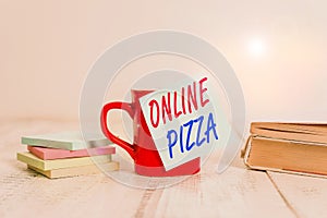 Text sign showing Online Pizza. Conceptual photo fast delivery of pizza at your doorstep Ordering food online Coffee cup