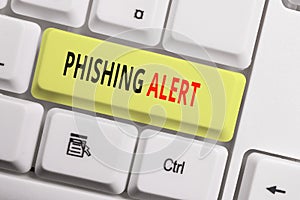 Text sign showing Phishing Alert. Conceptual photo aware to fraudulent attempt to obtain sensitive information White pc