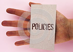 Text sign showing Policies. Conceptual photo Business Company or Government Rules Regulations Standards written on Cardboard Piece