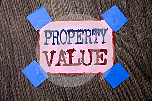 Text sign showing Property Value. Conceptual photo Estimate of Worth Real Estate Residential Valuation written on Pink Sticky Note