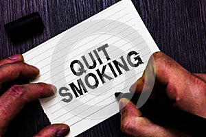 Text sign showing Quit Smoking. Conceptual photo Discontinuing or stopping the use of tobacco addiction Man holding marker noteboo