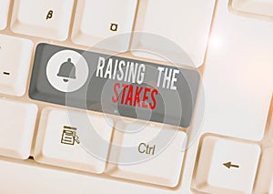 Text sign showing Raising The Stakes. Conceptual photo Increase the Bid or Value Outdo current bet or risk White pc photo