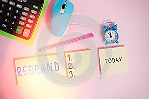 Text sign showing Rebrand. Conceptual photo Change corporate image of company organization Marketing strategy Notepads mouse alarm