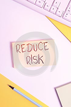 Text sign showing Reduce Risk. Conceptual photo lessen the potential damage that could be caused by a hazard Flat lay