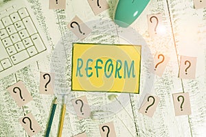 Text sign showing Reform. Conceptual photo to amend or improve by change of forms or removal of faults Writing tools, computer