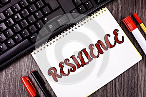 Text sign showing Resilience. Conceptual photo Capacity to recover quickly from difficulties Persistence written on Notepad on woo