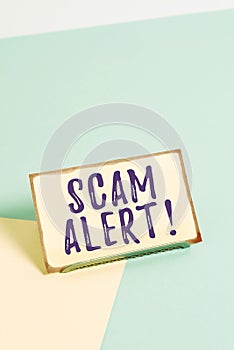 Text sign showing Scam Alert. Conceptual photo fraudulently obtain money from victim by persuading him Paper placed