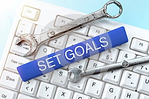 Text sign showing Set Goals. Word Written on Defining or achieving something in the future based on plan Hands Holding