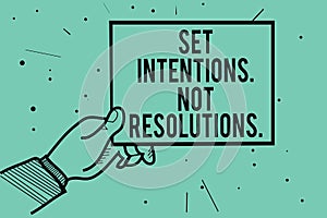 Text sign showing Set Intentions. Not Resolutions.. Conceptual photo Positive choices for new start achieve goals Man hand holding