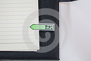 Text sign showing `Sign here` sticker on document on white paper Paper sheets