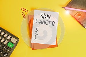 Text sign showing Skin Cancer. Conceptual photo uncontrolled growth of abnormal skin cells due to sun exposure Pile of