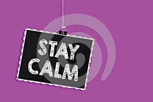 Text sign showing Stay Calm. Conceptual photo Maintain in a state of motion smoothly even under pressure Hanging blackboard messag
