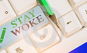 Text sign showing Stay Woke. Conceptual photo being aware of your surroundings and things going on Keep informed.