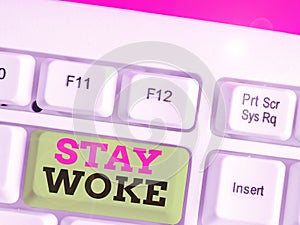 Text sign showing Stay Woke. Conceptual photo being aware of your surroundings and things going on Keep informed.